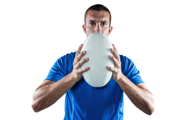 Portrait of rugby player in blue jersey holding ball