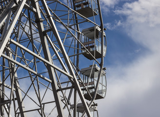part of a ferris wheel against a blue sky