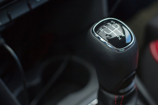 manual transmission gear shift on dark background, close-up