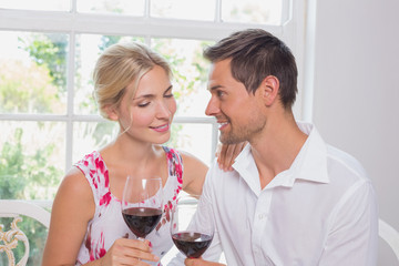 Happy loving young couple with wine glasses