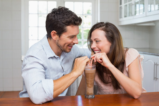 Loving Young Couple Sharing A Drink