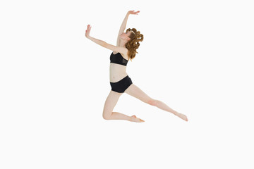 Fototapeta premium Full length of a sporty young woman jumping