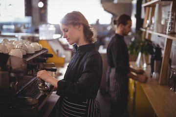 Side view of young baristas