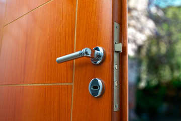 Obraz premium Open door of a family home. Close-up of the lock an armored door. Security.