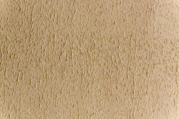 The background of beige walls are covered with splashes of plaster. Liquid volumetric Wallpaper.