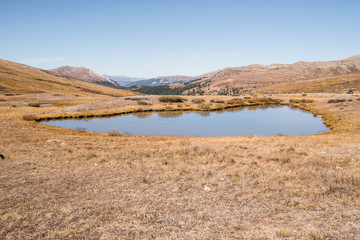 landscape view at Independence Pass near Aspen, Colorado of mountains and a pond. 