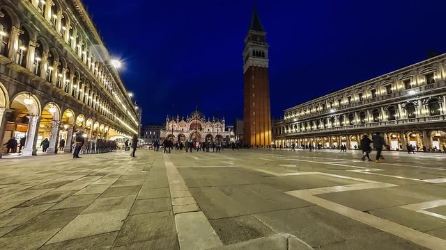 Piazza San Marco and Basilica of St Mark night timelapse. Cathedral church of Roman Catholic Archdiocese of Venice. Tourists walking in front of it. 4K