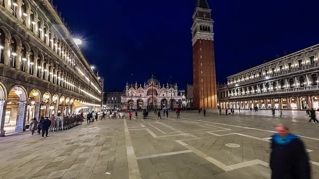 Piazza San Marco and Basilica of St Mark night timelapse. Cathedral church of Roman Catholic Archdiocese of Venice. Tourists walking in front of it. 4K