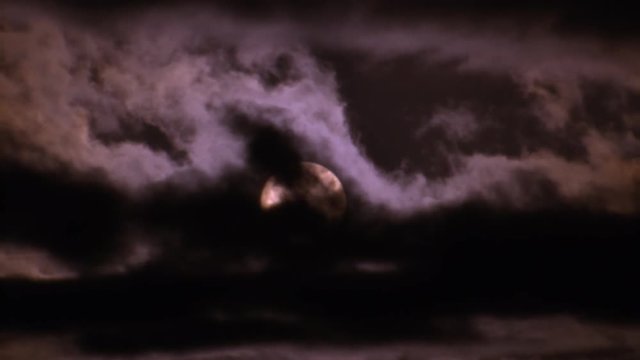 Night clouds drifting across full moon