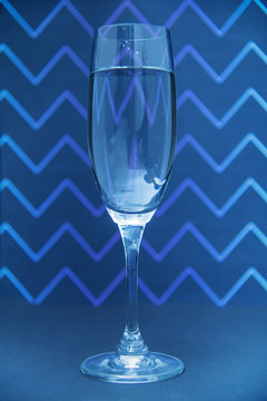 Glass of champagne on zig zga pattern background