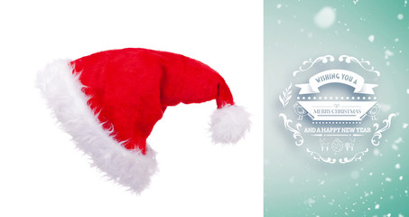 Snow falling against christmas hat