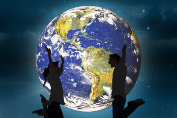 Obraz premium Couple jumping in the air against stars twinkling in night sky