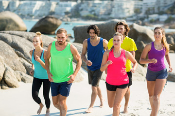 Friends jogging on shore