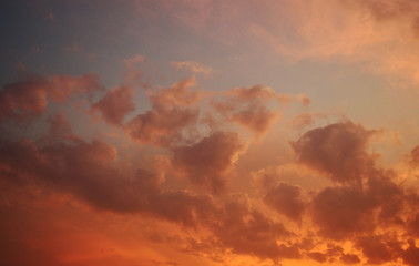 Orange with pink and gold color cloud on beautiful blue sky at sunset , Fluffy clouds formations at tropical zone
