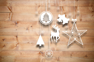 Fototapeta na wymiar Hanging christmas decorations against bleached wooden planks background