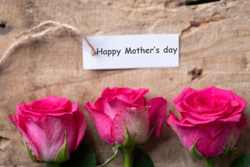Beautiful pink roses with Happy Mother's day tag card, top view