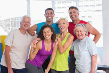 Cheerful people in sportswear at fitness gym