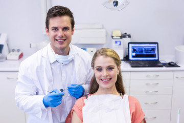 Portrait of happy dentist and female patient