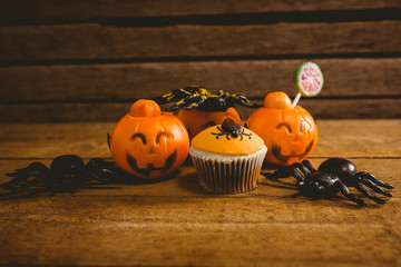 Halloween decorations with cup cake on table