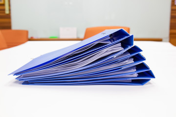 file folder with documents and retention of contracts on table in meeting room  