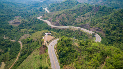 Asphalt road on the hill in Phetchabun province, Thailand. Aerial view from flying drone.