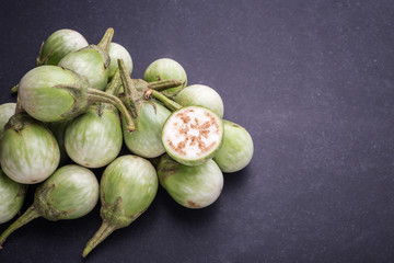 Top view fresh green Thai eggplant on black stone