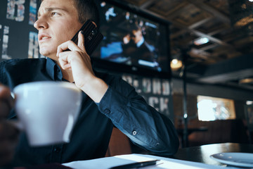 businesswoman talking on mobile phone in cafe
