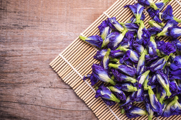 Top view fresh purple Butterfly pea flower on wooden board background