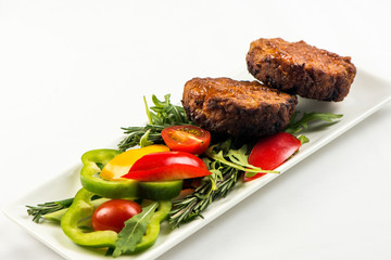 Fried cutlets and vegetable salad white plate on white background