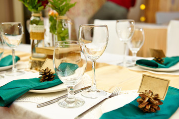 Festive table setting in the restaurant with flowers. Wedding decor.