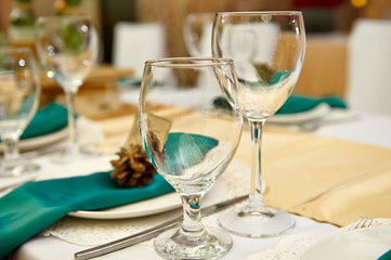 Festive table setting in the restaurant with flowers. Wedding decor.