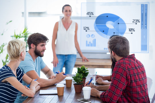 Casual businesswoman giving presentation to her colleagues against global business interface