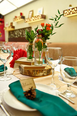 Festive table setting in the restaurant with flowers. Wedding decor.