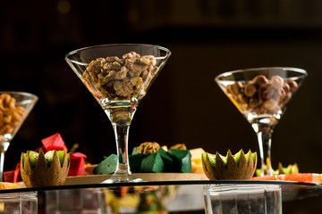 roasted peanuts isolated in glass bowl, on white background