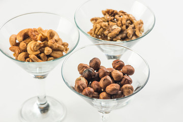 roasted peanuts isolated in glass bowl, on white background