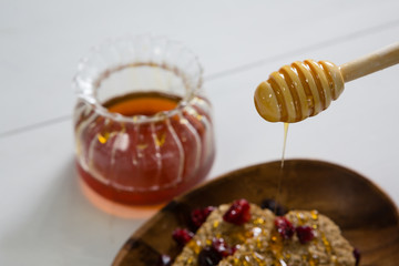 Honey pouring into a cereal bowl