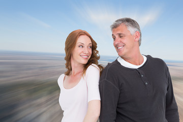 Obraz premium Casual couple smiling at each other against new york
