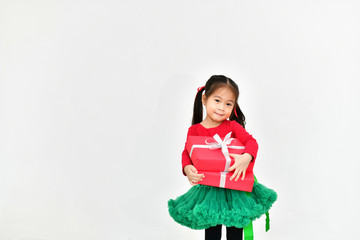 Little girl celebrates Christmas with red Santa dress.