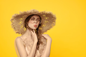 woman in hat with pigtails on a yellow background