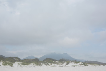Beach against the misty mountains