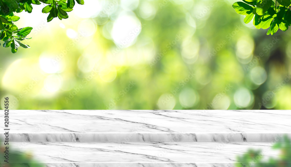 Aufkleber Empty white marble table top with blur tree in park with bokeh light at background,Mock up template for display of your design,Banner for advertise of product,panorama view