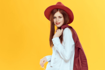 woman wearing red hat on yellow background