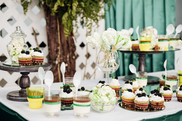 Desserts muffins and meringues on a table in a candy bar