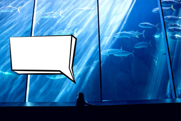 Speech bubble against little girl looking at fish tank
