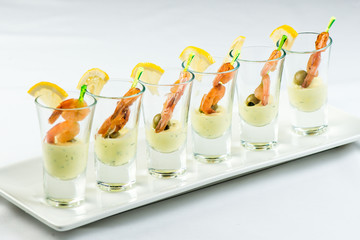 individual Cocktail Shrimp shot glasses with delicious homemade tartar spicy sauce decorated with...