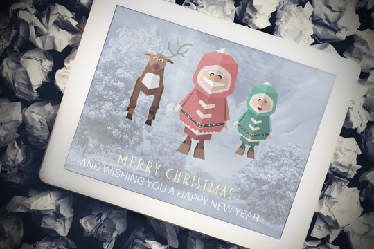 Santa elf and reindeer against tablet pc showing road image