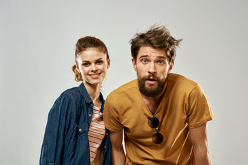 interested man with glasses on a T-shirt and a woman in a blue shirt