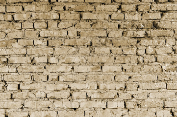 Part of the wall of brick pieces of an old building for demolition. Toning.