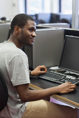 Man sitting at the computer looking up