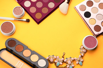 multicolored shadows on a table rouge and brushes on a yellow background...